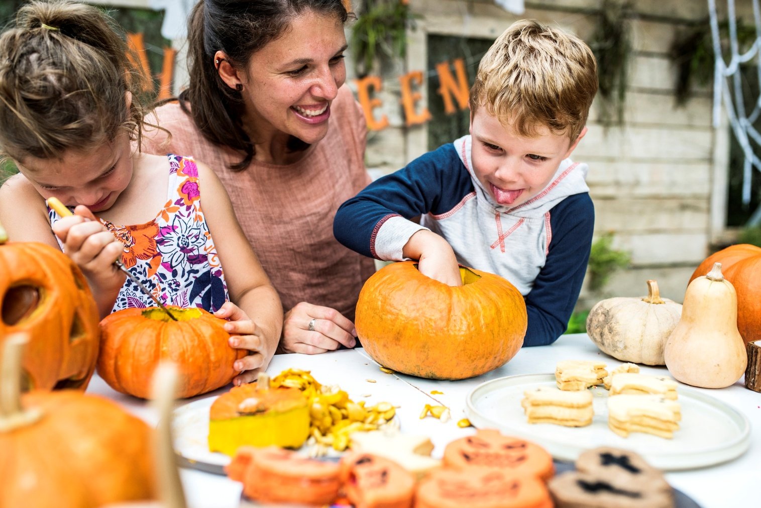 A person and children carving a pumpkin AI-generated content may be incorrect.